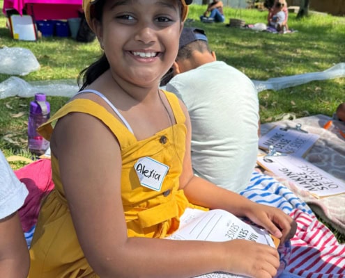 Primary school girl participating in activities during sensory play in a park with Think Digital Academy virtual school.