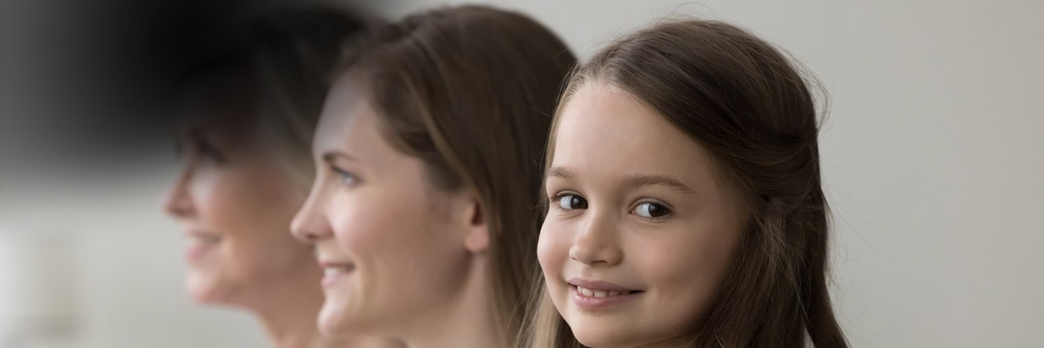 A primary school girl with her mother and grandmother.