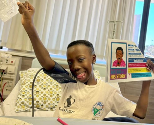 Primary school child in hospital celebrating the 2024 Nelson Mandela Day.