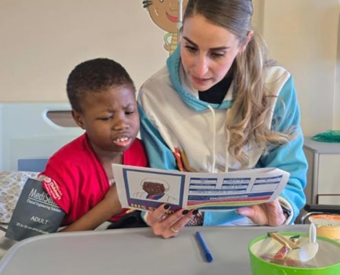 Young primary school child having an educational moment while in hospital.