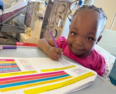 Little girl learning and having fun while in hospital.